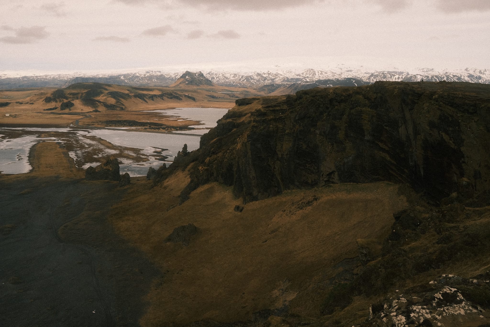 Coast and Glacier — Lagoons and cliffs front far snowy ranges.