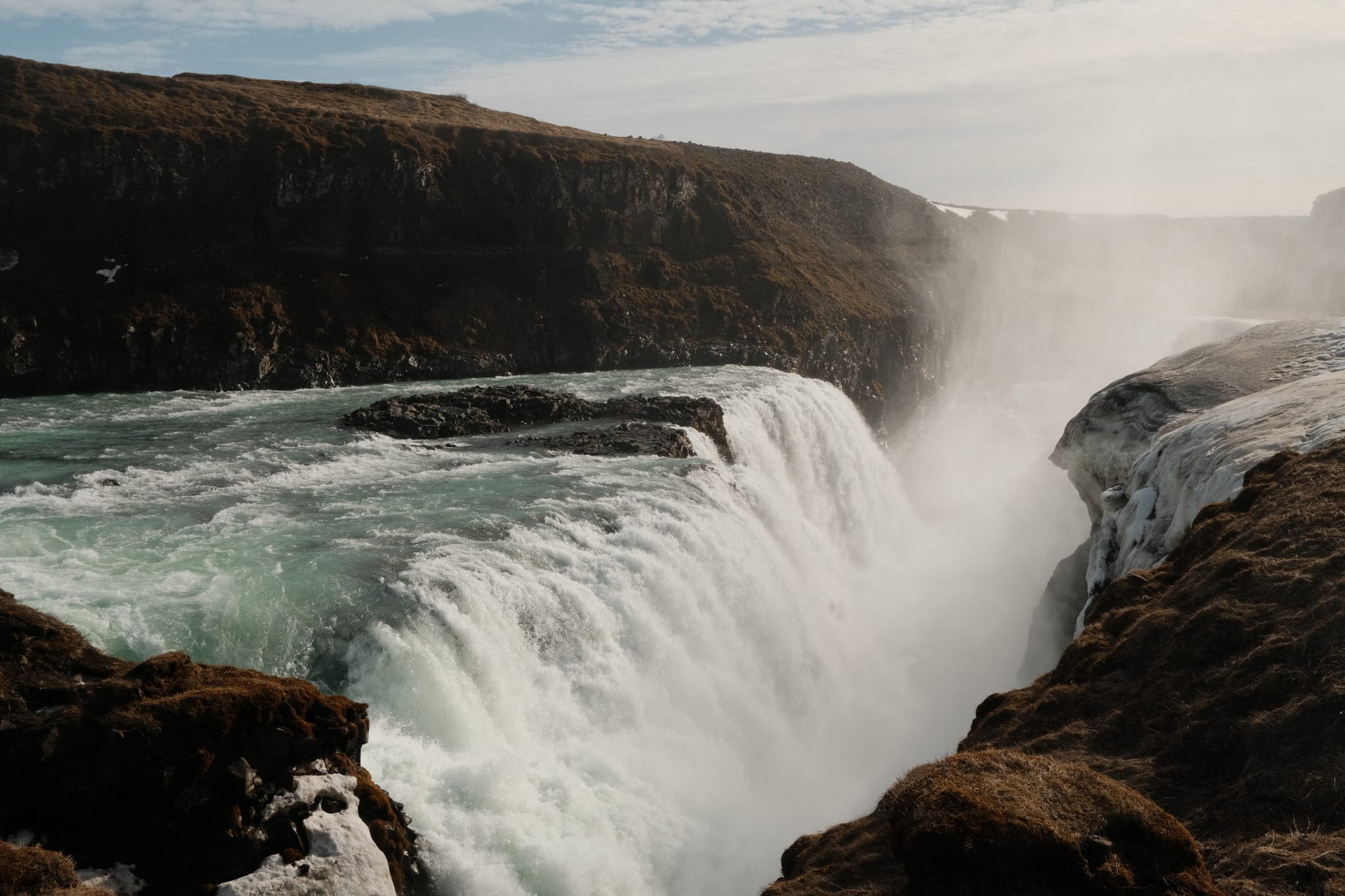 Into the Gorge — Glacial water pours over the falls' edge.